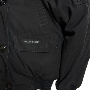 The front logo of the Canada Goose Chilliwack Womens Black Bomber Heritage.