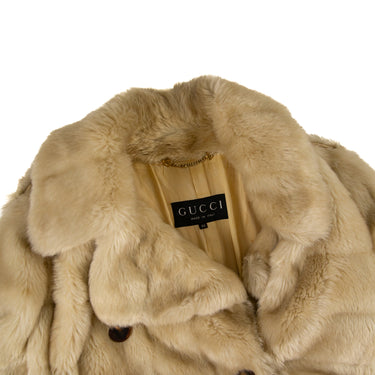 The collar and inside label of the Gucci Cream Faux Fur Short Coat.