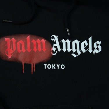 The logo of the Palm Angels Spray Logo Black Hoodie.