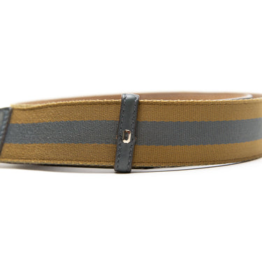 The buckle of the Gucci Blue & Yellow Striped Canvas Silver GG Buckle Belt.