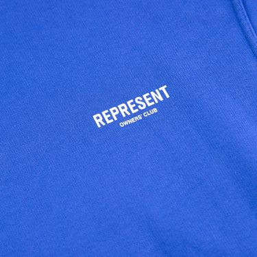 The logo of the Represent Owners Club Blue Hoodie.