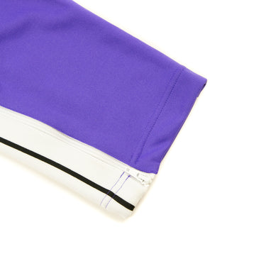 The leg of the Palm Angels Purple Sweatpants.