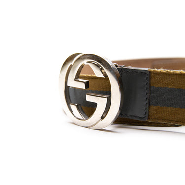 The buckle of the Gucci Blue & Yellow Striped Canvas Silver GG Buckle Belt.