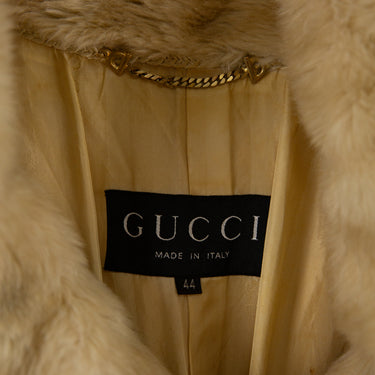 The inside label of the Gucci Cream Faux Fur Short Coat.