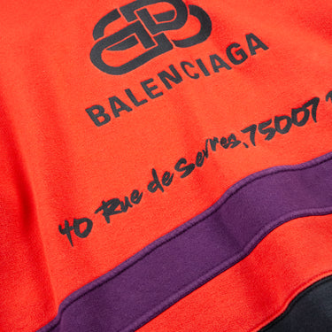 The logo on the Balenciaga Red Rive Gauci 1/4 Zip sweatshirt.