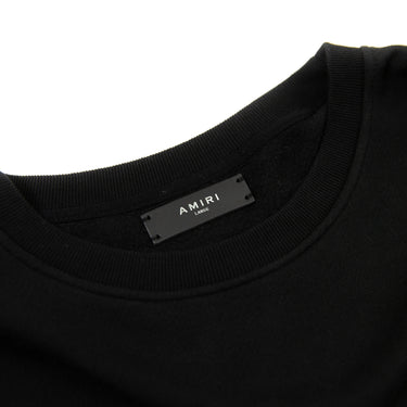 Shows the inside label of the Amiri Black A/W18 Children of the Night Vampire Sweatshirt.