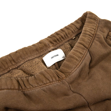 Inside view showing the label and band of Joah Brown sweatpants, in brown.