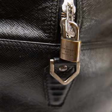 The logo of the Louis Vuitton Black Duffel Bag.
