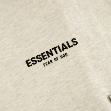 The logo of the Fear Of God ESSENTIALS Light Oatmeal Hoodie L.