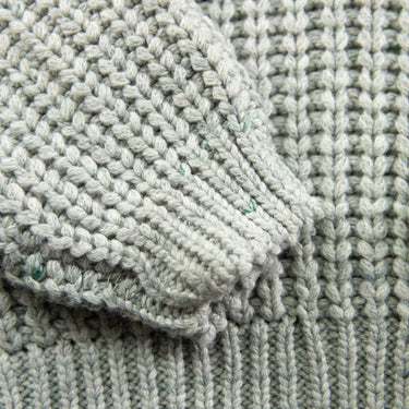 The sleeve of the Kith Lyon Grey Knit Sweater.