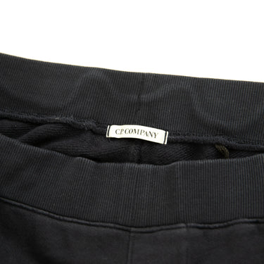 The inside label of the C.P. Company Navy Lens Sweatpants.