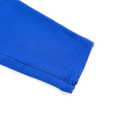 The leg of the Represent Owners Club Blue Sweatpants.