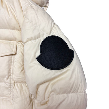The logo of the Moncler Twist Huarez Cream Puffer Jacket.