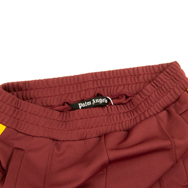 The inside label of the Palm Angels Burgundy & Yellow Sweatpants.
