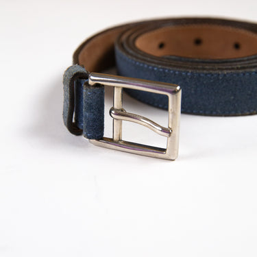 Shows the buckle of a blue leather Gucci belt.