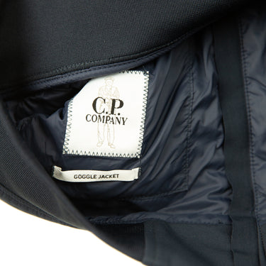 The inside label of the C.P. Company Navy Shell-R Goggle Jacket.