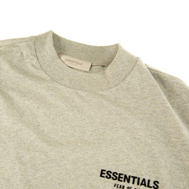 The collar of the Fear Of God ESSENTIALS Dark Oatmeal T Shirt.