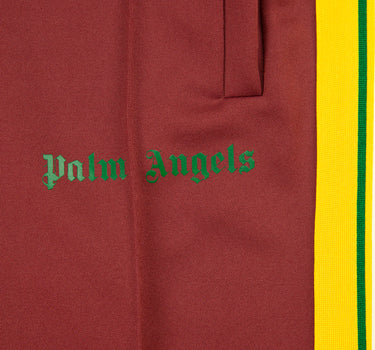 The logo of the Palm Angels Burgundy & Yellow Sweatpants.