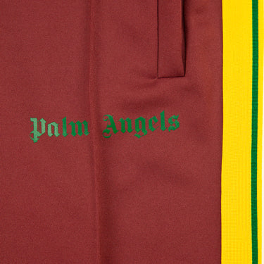 The logo of the Palm Angels Burgundy & Yellow Sweatpants.