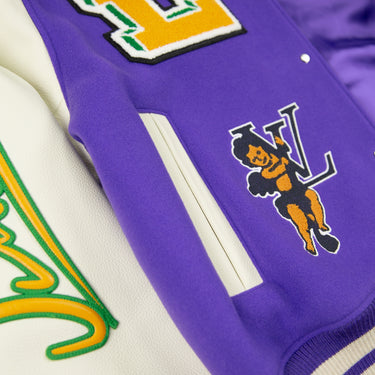A close-up detail of a Louis Vuitton Multi-Patches Mixed Leather Varsity Jacket in purple with white sleeves and orange patches.