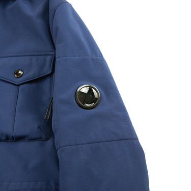 The arm logo of the C.P. Company Navy Goggle Soft Shell Jacket.