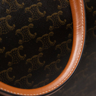 The detail of the Celine Voyage bag in Triomphe Canvas with Celine print.