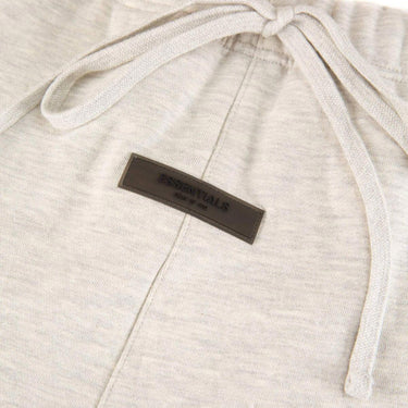 The logo of the Fear Of God ESSENTIALS Light Oatmeal Sweatpants L.