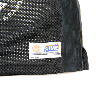 The logo of the Aime Leon Dore Stadium Cropped Practice Black Jersey.