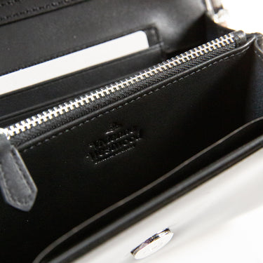 Inside view showing the logo of a Vivienne Westwood Patent Leather Crossbody Bag in black.