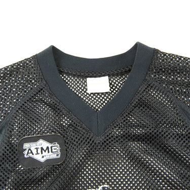 The logo of the Aime Leon Dore Stadium Cropped Practice Black Jersey.