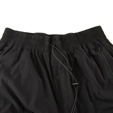 The waistband of the Represent Black Cargo Trousers.