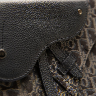 The detail of the Dior Black Oblique Saddle Bag.