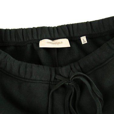 The inside label of the Fear Of God ESSENTIALS Stretch Limo Sweatpants.