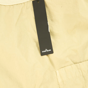 The tags of the Stone Island Naslan Light Crewneck Beige Sweatshirt.