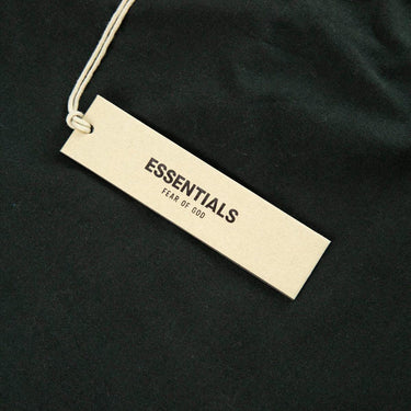The tags of the Fear Of God ESSENTIALS Stretch Limo T Shirt S.