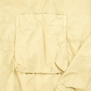 The pocket of the Stone Island Naslan Light Crewneck Beige Sweatshirt.