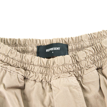 The label of the Represent Beige Cargo Trousers.