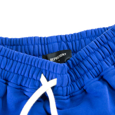 The waistband of the Represent Owners Club Blue Sweatpants.