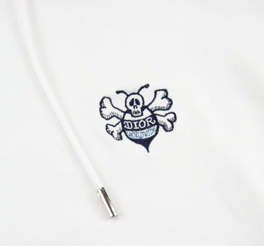 The logo of the Dior x Kaws Bee Embroidered White Hoodie.