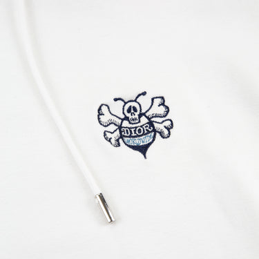 The logo of the Dior x Kaws Bee Embroidered White Hoodie.