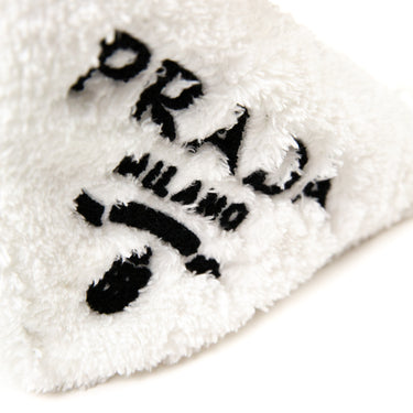 Shows the logo on a Prada White Terrycloth Triangle Bag.