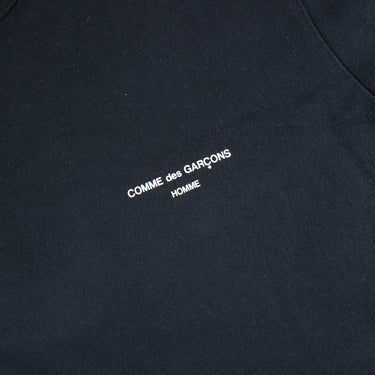 The logo of the Comme Des Garçons Homme Black T Shirt.