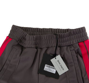 The tags of the Palm Angels Grey & Pink Sweatpants.