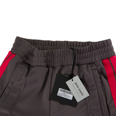 The tags of the Palm Angels Grey & Pink Sweatpants.