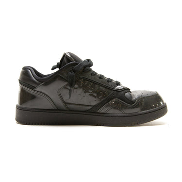 The left of the Dior B27 Low Black Patent Dior Oblique Trainers.