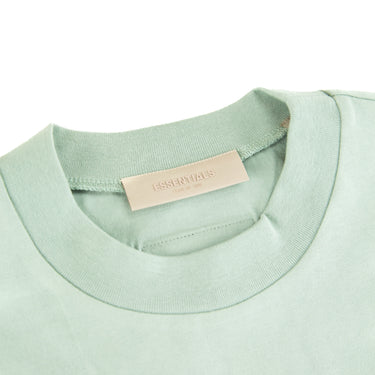 The inside label of the Fear Of God ESSENTIALS Sycamore T Shirt.