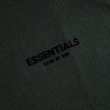 The logo of the Fear Of God ESSENTIALS Stretch Limo T Shirt M.