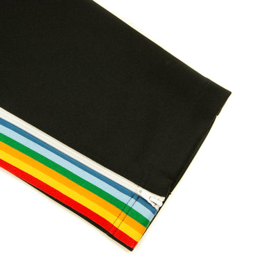 The leg of the Palm Angels Rainbow Black Sweatpants.