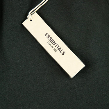 The tags of the Fear Of God ESSENTIALS Stretch Limo Sweatshorts Shorts XS.