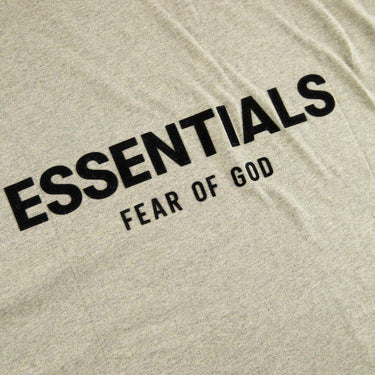 The logo of the Fear Of God ESSENTIALS Dark Oatmeal T Shirt.